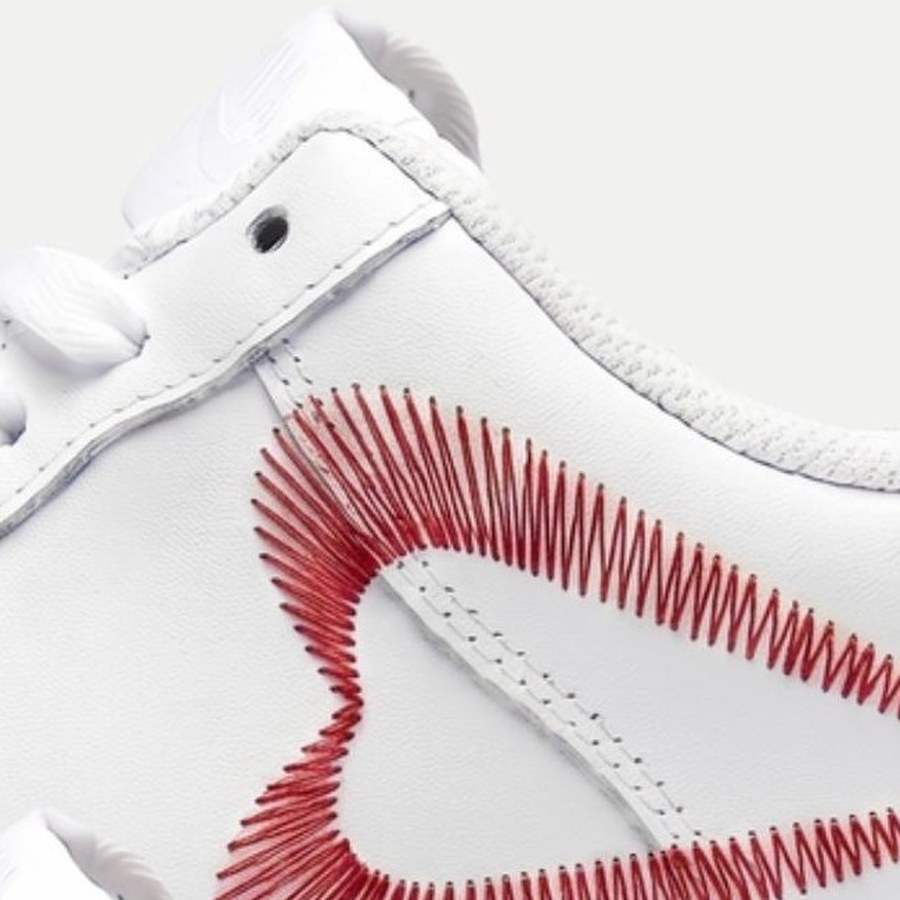 Close-up of the same heart shape stitched as a clean, open running-stitch outline instead of a filled shape